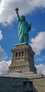 Low angle view of statue against cloudy sky