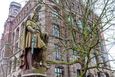 Low angle view of statue against trees