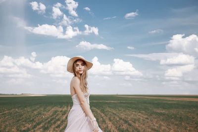 Portrait of a smiling young woman on field