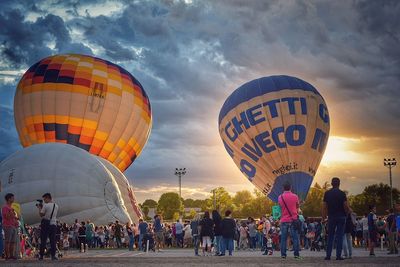 People against sky at sunset