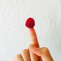 Close-up of hand holding strawberry