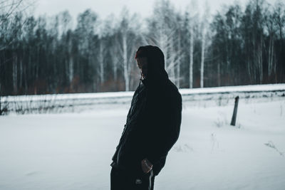 Man standing on snow covered land