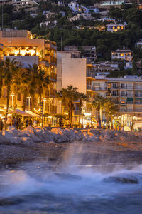 Illuminated buildings in city at night