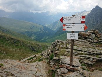 Information sign on landscape against mountains