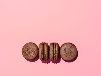 Close-up of cookies against pink background