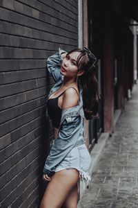 Portrait of beautiful woman against wall