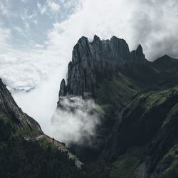 Panoramic view of mountain range against cloudy sky