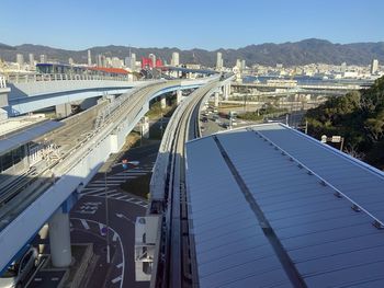 High angle view of highway and cityscape against sky