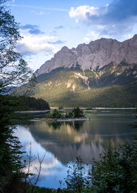 Scenic view of lake and mountains against sky