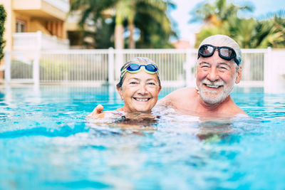 Portrait of smiling man swimming in pool