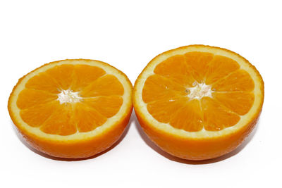 Close-up of orange slice against white background