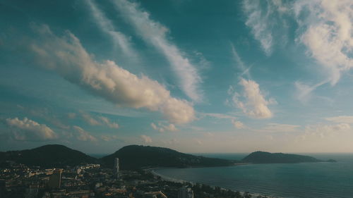 Panoramic view of city by sea against sky