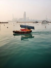 Boat sailing in sea against sky