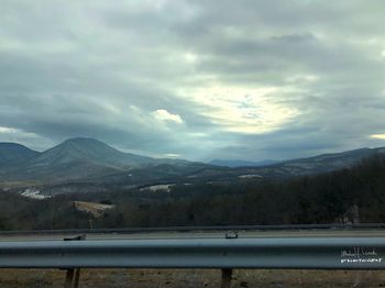 Scenic view of mountains against cloudy sky