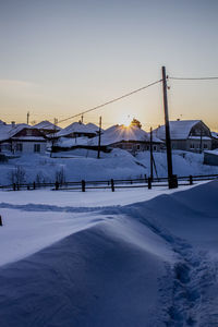 Scenic view of snow covered mountain against sky during sunset