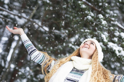 Portrait of a smiling young woman in snow