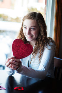 Young woman holding valentine heart