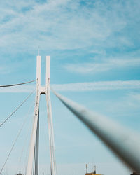 Low angle view of suspension bridge against sky