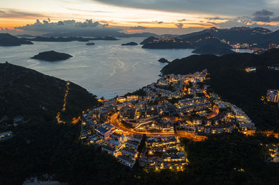 High angle view of illuminated buildings against sky during sunset
