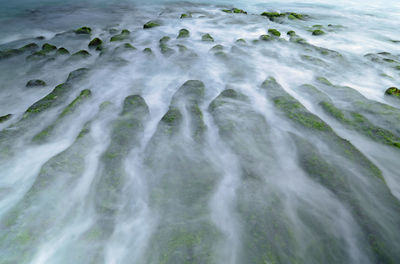 High angle view of rocks in sea