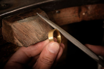 Close-up of human hand making ring in workshop