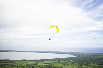 Person paragliding against sky