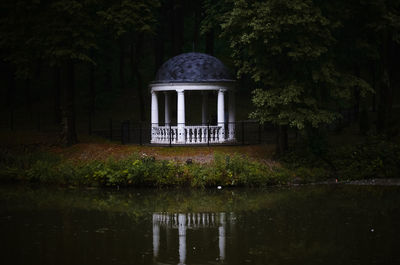 Built structure by lake in forest