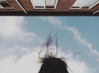 Low angle view of woman against sky