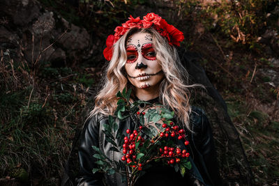 Closeup portrait of calavera catrina. young woman with sugar skull makeup and red flowers. dia 