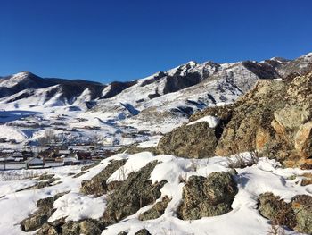 Scenic view of snow mountains against clear blue sky