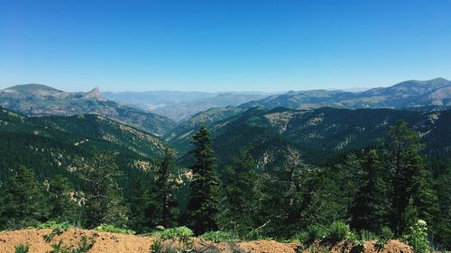 Scenic view of mountains against clear blue sky