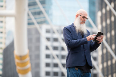 Midsection of man using mobile phone