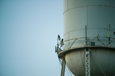 Low angle view of water tower against clear sky