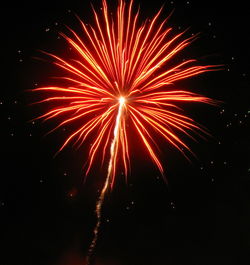 Low angle view of firework display against sky at night