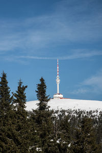 Low angle view of communications tower against sky