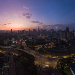 High angle view of street and buildings against sky during sunset