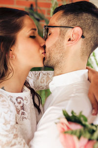 Midsection of couple kissing