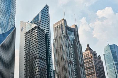 Low angle view of modern buildings against sky in city