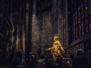 Rear view of man statue in city