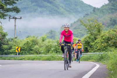 Man riding bicycle on road