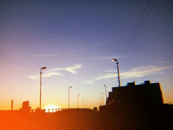 Low angle view of silhouette buildings against sky during sunset