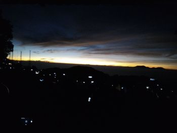 Scenic view of silhouette landscape against sky at night