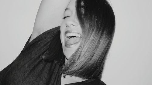 Close-up of young woman against white background