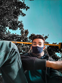 Portrait of young man against sky during winter