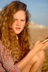 Close-up of teenager against sky