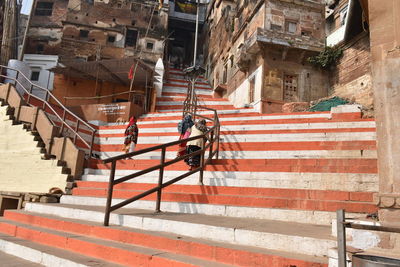 People working on street amidst buildings in city