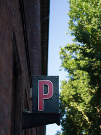 Low angle view of road sign against trees