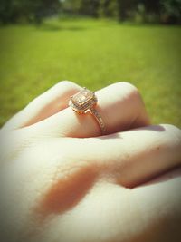 Close-up of hands holding ring