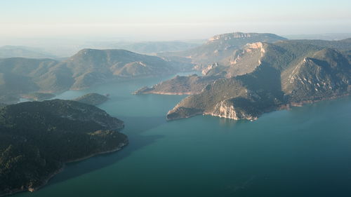 High angle view of lake and mountains against sky