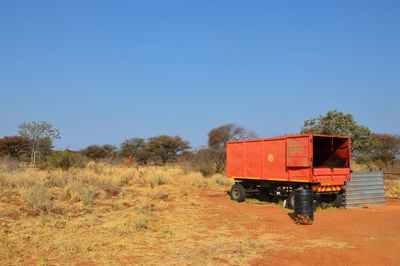 Car on landscape against clear sky